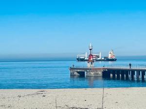 a dock on the water with a boat in the water at Love Gioia Tauro in Gioia Tauro +17 photos