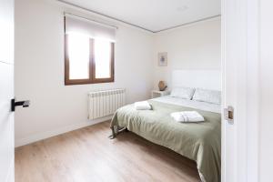 Ένα ή περισσότερα κρεβάτια σε δωμάτιο στο Arena - El Silencio Apartamentos