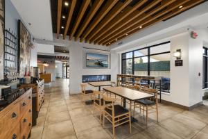 a dining room with tables and chairs and a fireplace at Lake Placid Inn Boutique Hotel in Lake Placid