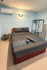 a large bed in a room with at Neela House in Labuan +15 photos