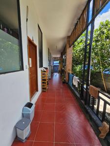a hallway of a house with a red tiled floor at Top View Kohrong in Koh Rong