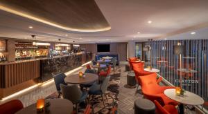 a restaurant with tables and chairs and a bar at Clayton Hotel Cardiff Lane in Dublin
