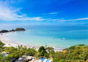 a view of a beach with boats in the water at Stunning 2 Bedroom Apartment in Punta Esmeralda , Costa Rica in Punta Leona