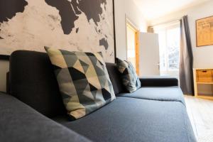 a living room with a couch and a map on the wall at T2 chic et confortable au centre d Epernay in Épernay