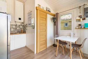 a small kitchen with a table and a small refrigerator at Lodge Natura in Ambérieu-en-Bugey