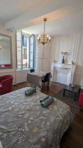 a bedroom with a bed with two pillows on it at Appartement Hyper Centre, 1er étage in Fougères