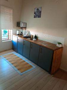 a kitchen with a sink and a counter top at Ekuphumleni Holistic Healing Center in Johannesburg