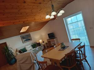 a living room with a table and a couch at Casa Gina in Roana +23 photos