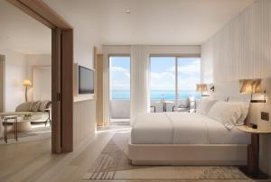 a bedroom with a bed with a view of the ocean at Delano Miami Beach in Miami Beach +107 photos
