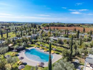 an aerial view of a resort with a pool and trees at Hotiday Lodge Cecina in Cecina