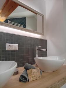 a bathroom with two sinks and a mirror at Ferienhaus Herrenschmiede in Obervellach +58 photos