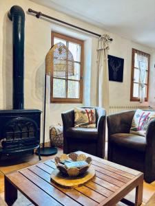 a living room with a table and a stove at Chalet Pierre-vue sur le Pelvoux in Risoul