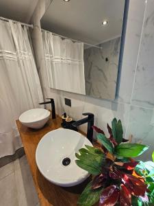 a bathroom with a white sink and a mirror at CasaDelSUr in San Carlos de Bariloche