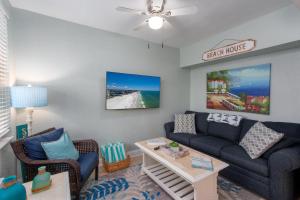 a living room with a couch and chairs and a table at Clearwater Beach Suites #106 in Clearwater Beach