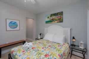 a bedroom with a bed with towels on it at Clearwater Beach Suites #106 in Clearwater Beach +35 photos