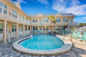 a swimming pool in front of a building with a resort at Clearwater Beach Suites #106 in Clearwater Beach