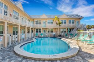a swimming pool in front of a building with a resort at Clearwater Beach Suites #104 in Clearwater Beach