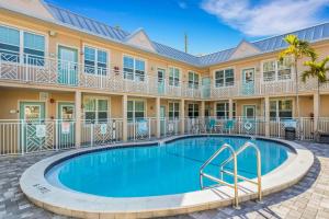 a swimming pool in front of a house with a building at Clearwater Beach Suites #104 in Clearwater Beach +15 photos