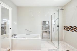 a white bathroom with a sink and a shower at Nancy's 3 bedroom house near Heathrow Airport in Hounslow +87 photos