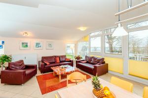 a living room with couches and a table at Residenz Meeresblick B Fewo 4 in Rerik