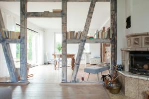 a living room with a large wooden ladder in a room at Idyllic Home Between Fields And Elbe Dyke in Eickerhöfe