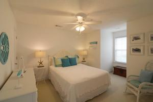a bedroom with a bed and a ceiling fan at #3 B 18th Place in Tybee Island