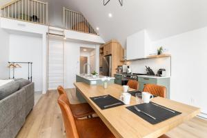 a kitchen and dining room with a wooden table and chairs at Flocon Marin 1229 in Petite-Rivière-Saint-François +8 photos