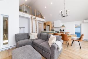 a living room with a couch and a dining room at Flocon Marin 1229 in Petite-Rivière-Saint-François