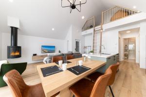 a kitchen and living room with a wooden table and chairs at Flocon Marin 1229 in Petite-Rivière-Saint-François