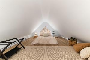 a bedroom with a bed in a white wall at Flocon Marin 1229 in Petite-Rivière-Saint-François