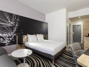 a hotel room with a bed and a living room at Novotel Tours Centre Gare in Tours +59 photos