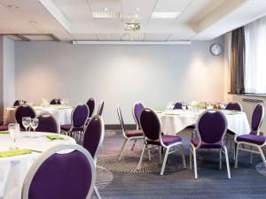 a conference room with tables and purple chairs at Novotel Tours Centre Gare in Tours