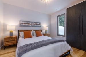 a bedroom with a large white bed and a window at Le Rupin 77: Luxury Contemporary, Spa, River View in Petite-Rivière-Saint-François +22 photos