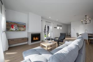 a living room with a couch and a fireplace at Panorama 1249: Garden-Level with Fireplace in Petite-Rivière-Saint-François