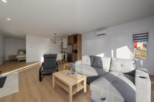 a living room with a couch and a table at Panorama 1249: Garden-Level with Fireplace in Petite-Rivière-Saint-François