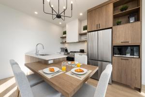a kitchen with a wooden table with chairs and a sink at Panorama 1249: Garden-Level with Fireplace in Petite-Rivière-Saint-François