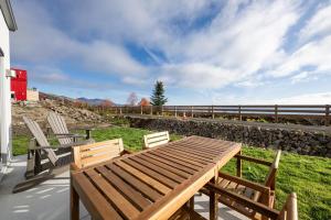 a wooden table and two chairs on a patio at Panorama 1249, Majestic River View, Spacious Patio in Petite-Rivière-Saint-François
