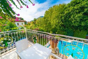 a balcony with chairs and a vase on it at Villa Garden Island in Dalyan