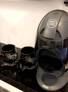 a coffee maker with two cups on a counter at شقة الخالدية 1 in Medina +8 photos