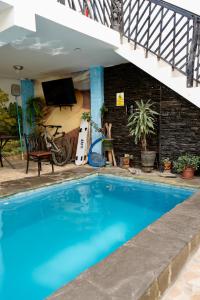 a large blue swimming pool next to a house at Hospedaje Mayo Huacachina in Ica
