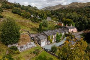 an aerial view of an old house on a hill at 2 Hart Head Barn, Renovated Barn, Ambleside in Rydal