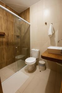 a bathroom with a toilet and a shower and a sink at Pousada o pescador in Icapuí +11 photos
