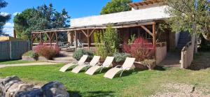 a group of white chairs sitting in a yard at Casa Mirlo in Montmesa