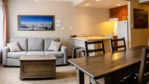 a kitchen and living room with a couch and a table at Cahilty #346 home in Sun Peaks