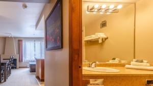 a bathroom with a sink and a large mirror at Cahilty #346 home in Sun Peaks