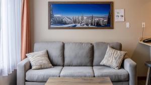 a living room with a couch and a picture on the wall at Cahilty #346 home in Sun Peaks