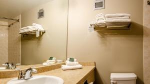 a bathroom with a sink and a mirror and towels at Cahilty #346 home in Sun Peaks +5 photos