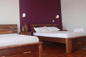 Postel nebo postele na pokoji v ubytování Résidence MIANTSOARIVO Guest House + 31 fotografií
