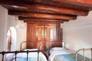 a bedroom with a bed with a wooden canopy at Ferienhaus In Mavrikiano Mit Privatem Pool in Elounda