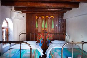 a bedroom with two beds and a wooden headboard at Ferienhaus In Mavrikiano Mit Privatem Pool in Elounda